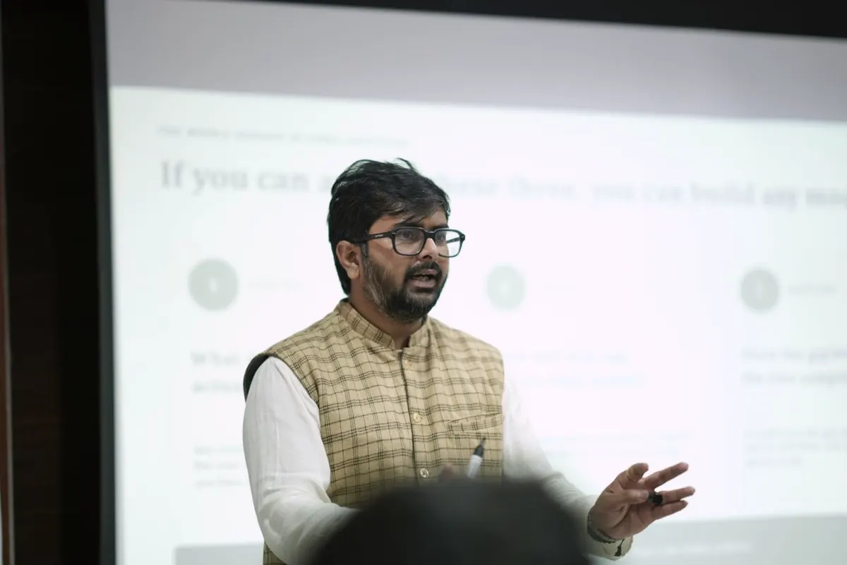 Karthik Beknal teaching a cohort of founders, a slide behind him